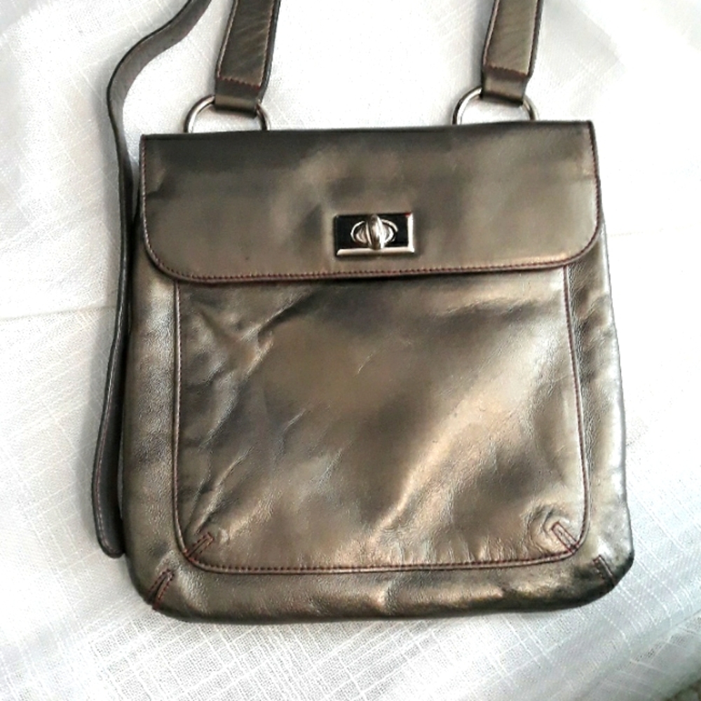 Tusk metallic silver leather and red fabric lined cross body bag. 9 x 9